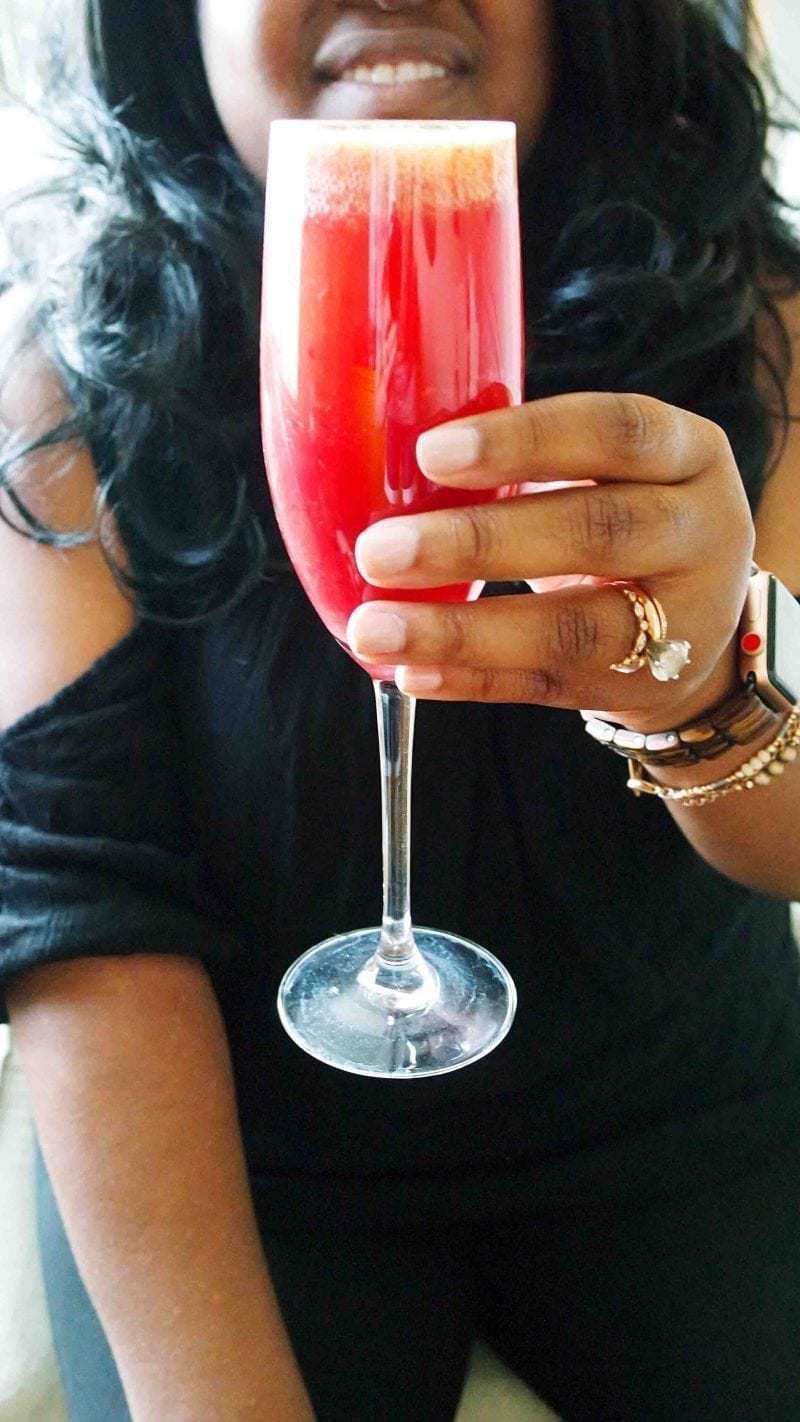 holding a blood orange mimosa