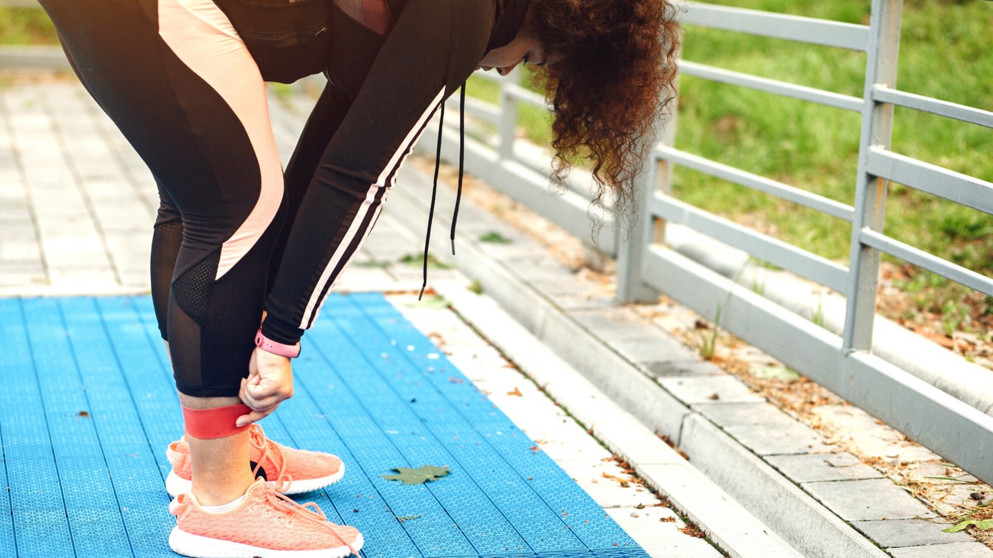Girl stretching in black and pink pants
