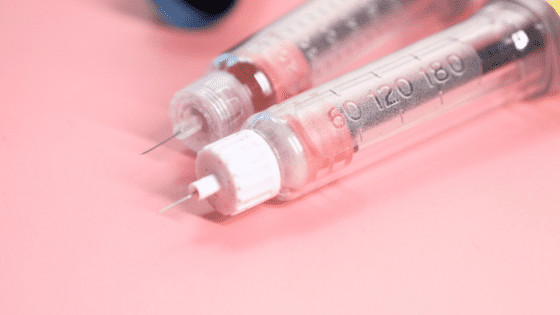 insulin pens lying on pink table