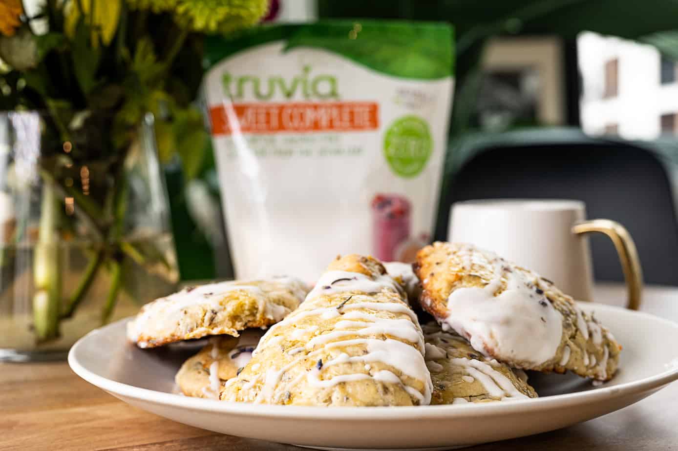 Lemon and lavender scones with a cup of tea and truvia sweet complete on a table.