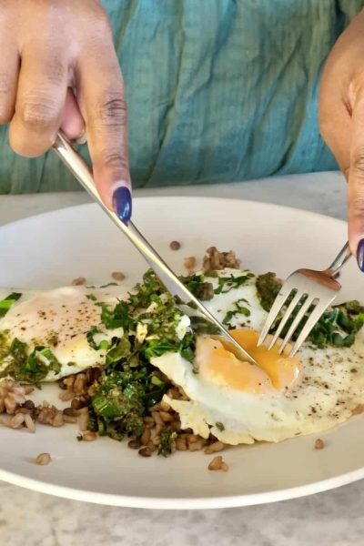 Egg and Pesto Breakfast Grain Bowl cut with a fork and knife