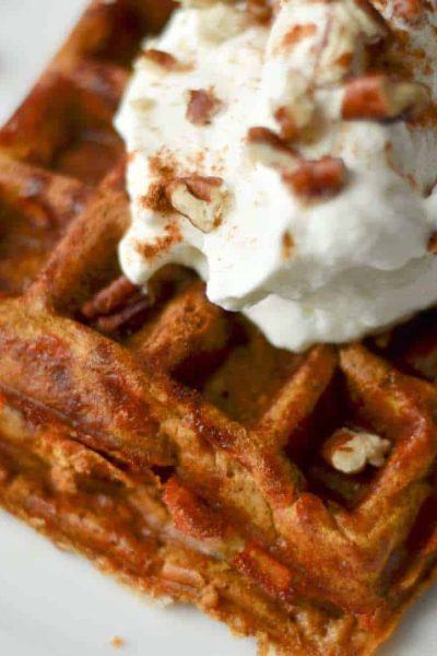 Pumpkin pie chaffle with whipped cream and pecans on top